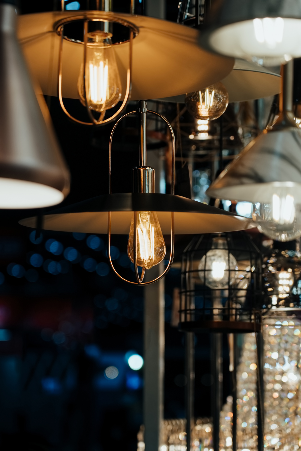 Many hanging lamps displayed in a showroom